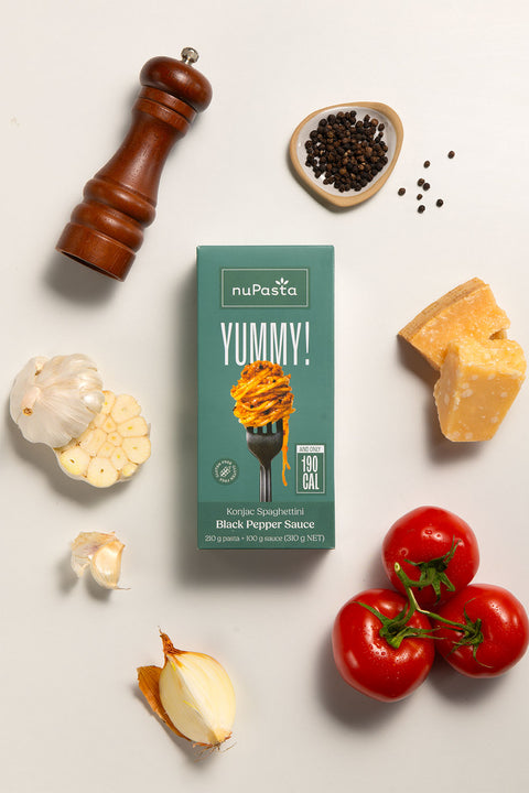 nuPasta Black Pepper Sauce meal kit with black pepper, tomatoes, and cheese on a light background