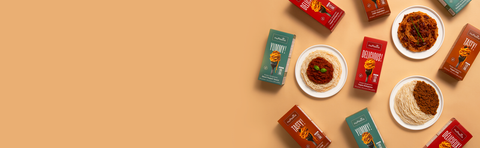 nuPasta meal kit boxes and plates of food on a beige background